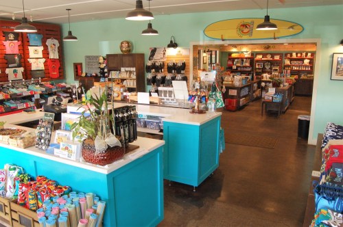 Brightly colored gift shop interior with merchandise displays, a checkout counter, and a welcoming atmosphere.