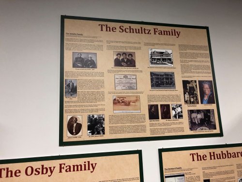 A display board featuring historical information and photos about the Schultz family, with text and images.