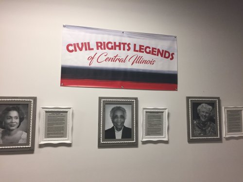 Banner reading "Civil Rights Legends of Central Illinois" above framed portraits and descriptions of notable figures.