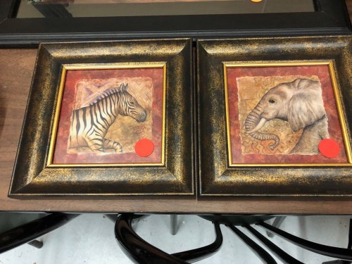Two framed animal illustrations: a zebra on the left and an elephant on the right, both with decorative backgrounds.