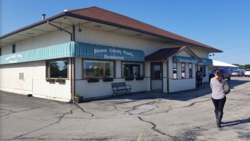 Exterior of Boone County Family Restaurant, featuring a light blue awning and a woman walking towards the entrance.