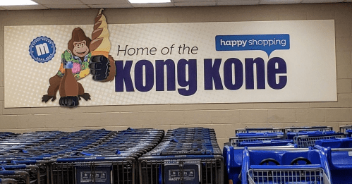 Sign featuring a cartoon gorilla holding an ice cream cone, promoting the "Kong Kone" at a shopping location.