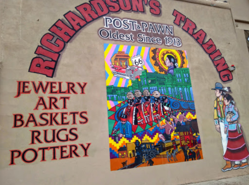 Colorful mural on a building featuring "Richardson's Trading" with images of Route 66, jewelry, and local art.