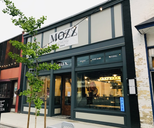 Exterior of Mozz Italian Pizza restaurant in Provo, featuring a modern design and an "Open" sign in the window.