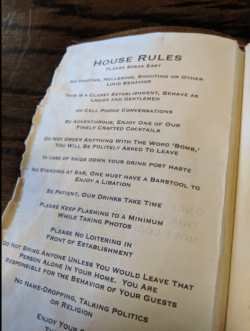 A menu page listing house rules for a bar, including guidelines on behavior and drink service.