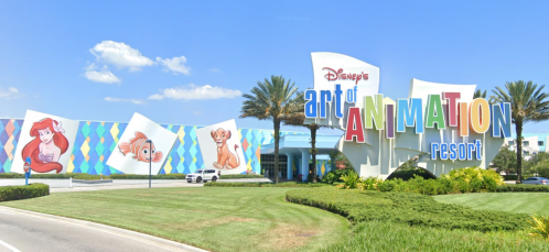 Colorful entrance to Disney's Art of Animation Resort featuring characters like Ariel, Nemo, and Simba. Lush landscaping surrounds it.