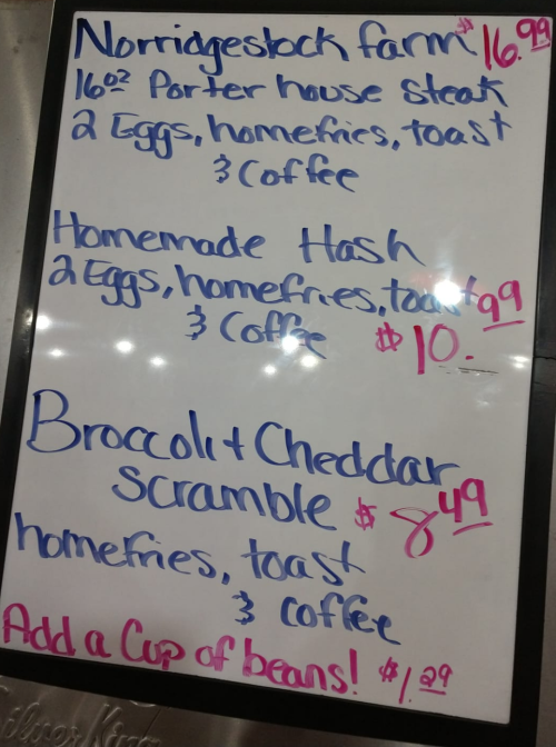 Menu board featuring three breakfast items with prices: Porter house steak, homemade hash, and broccoli & cheddar scramble.