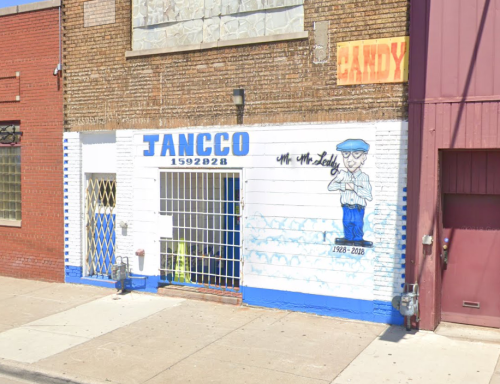 A colorful mural on a brick building featuring a cartoon character and the text "Mr. McLeddy 1926-2018."