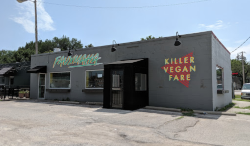 Exterior of a restaurant with a sign reading "Killer Vegan Fare" and a colorful "FroMaha" logo on the building.