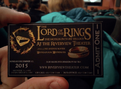 A hand holding a ticket for "The Lord of the Rings" at the Riverview Theater, dated December 27, 2015.