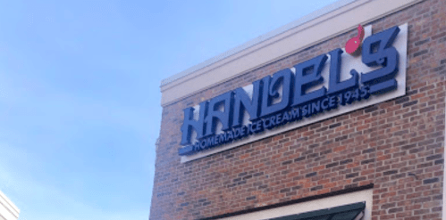 Sign for Handel's Homemade Ice Cream, established in 1945, on a brick building with a blue sky above.