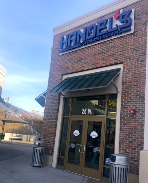 Exterior of Handel's Homemade Ice Cream shop, featuring a brick facade and green awning, with a sign above the entrance.