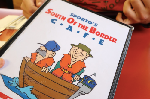 Menu cover for "Sporto's South of the Border Café," featuring two cartoon fishermen in a boat.