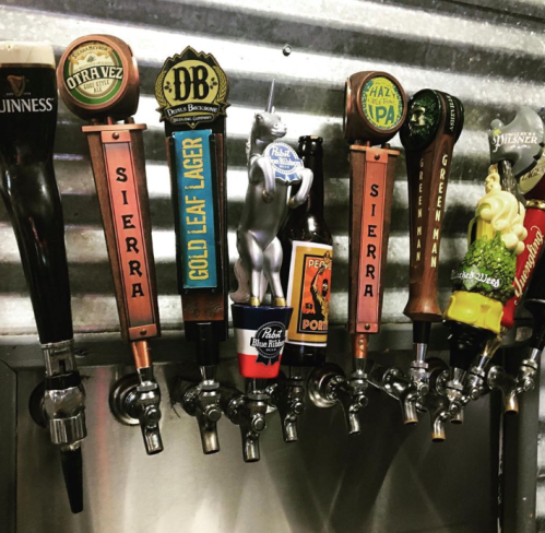 A row of beer taps featuring various brands and styles, including Sierra, Gold Leaf Lager, and Hazy IPA.