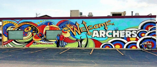 Colorful mural featuring the text "Welcome Archers" with abstract designs and patterns in vibrant hues.