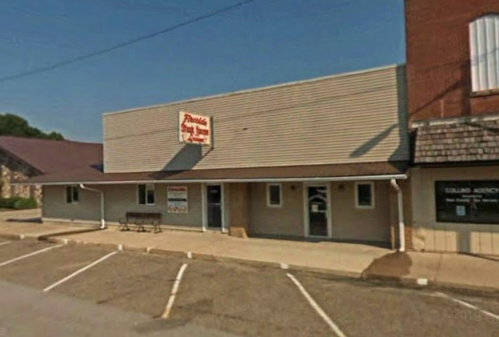 A small, one-story building with a sign reading "Parker's" and a parking lot in front, set in a quiet street.