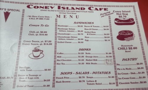 Menu from Coney Island Café featuring sandwiches, drinks, soups, and pastries with prices listed.