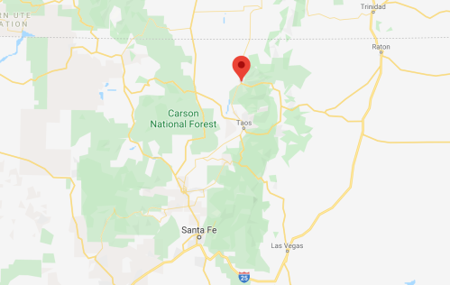 Map showing the location of Taos, New Mexico, near Carson National Forest, with a red marker indicating a specific point.