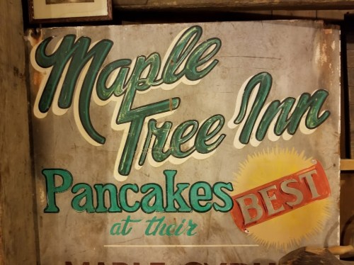 Sign for Maple Tree Inn featuring the text "Pancakes at their BEST" with a sun graphic.