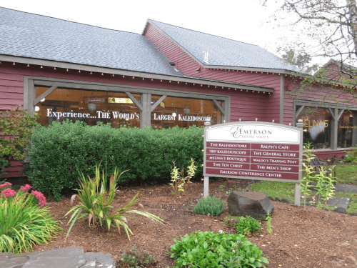 Signage for Emerson Resort & Spa, featuring attractions like the world's largest kaleidoscope and various shops.