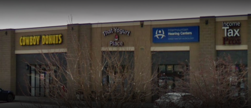Storefronts of Cowboy Donuts, That Yogurt Place, Intermountain Hearing Centers, and Income Tax Pros.