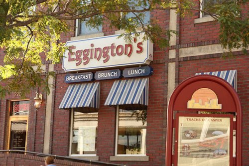 Sign for Eggington's restaurant featuring blue and white striped awnings, promoting breakfast, brunch, and lunch.
