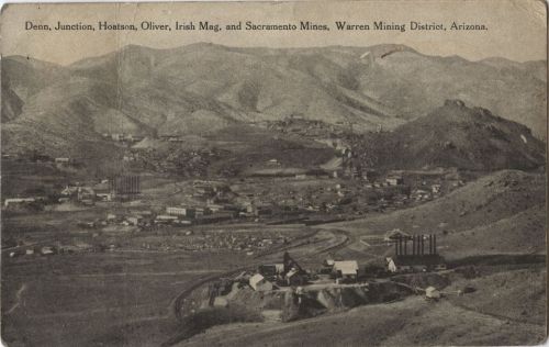 A vintage postcard view of the Warren Mining District in Arizona, showcasing mountains and mining structures.