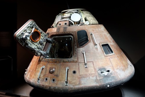 A vintage spacecraft with an open hatch, showcasing its weathered exterior and intricate details.