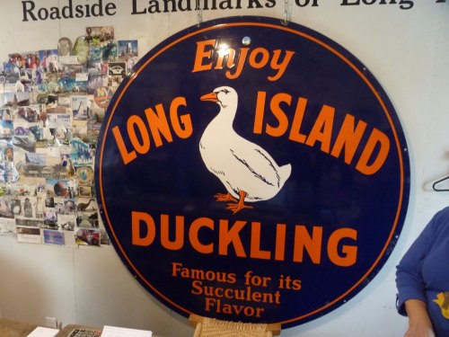 Sign promoting "Long Island Duckling," featuring a duck illustration and text about its famous flavor.