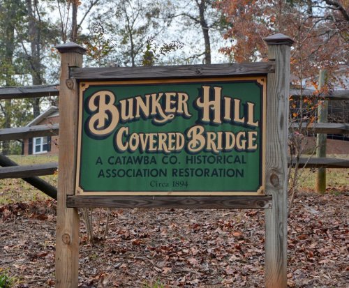 Sign for Bunker Hill Covered Bridge, a historical restoration by Catawba County, established in 1894.