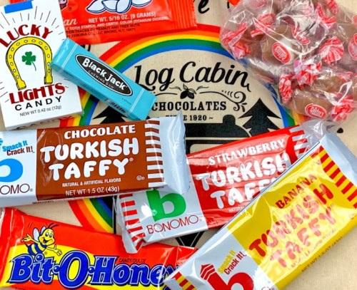 A colorful assortment of retro candies, including Turkish Taffy, Blackjack, and Log Cabin Chocolates on a patterned background.