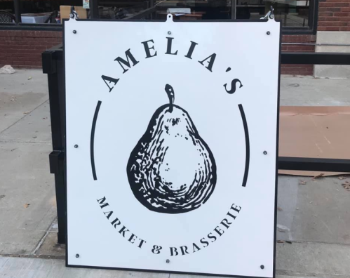 Sign for "Amelia's Market & Brasserie" featuring a pear illustration.