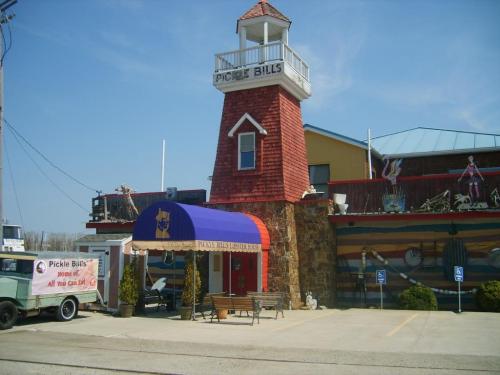 A colorful restaurant with a lighthouse design, featuring a sign for "Pickle Bill's" and outdoor seating.