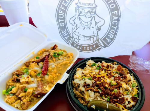 A takeout meal featuring two containers: one with chicken and vegetables, the other with cheesy meat and toppings, alongside a logo bag.