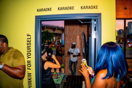 A lively karaoke scene with people singing and enjoying themselves in a vibrant setting.