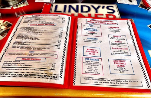 Menu from Lindy's Diner featuring seafood specials, desserts, and ice cream options. Colorful and well-organized layout.