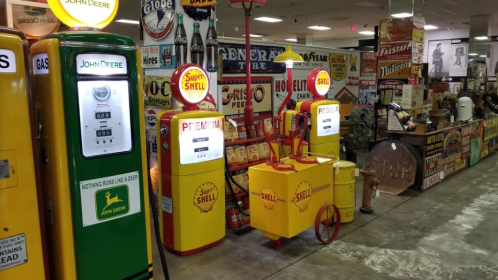 Vintage gas pumps and retro signage in a nostalgic display at a museum or antique shop.