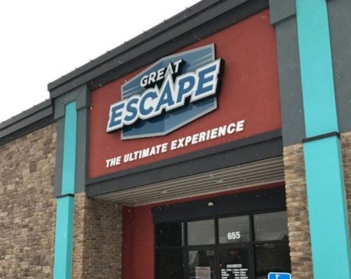 Exterior of the Great Escape building, featuring a colorful sign and snow on the ground. Accessible entrance visible.