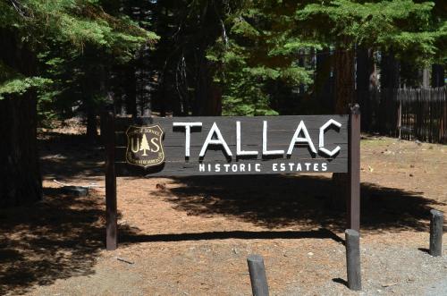 Sign for Tallac Historic Estates surrounded by trees, with a U.S. Forest Service emblem.