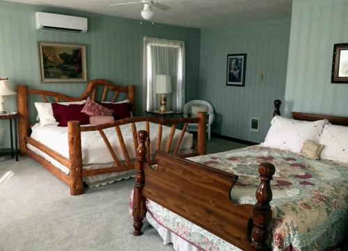 Cozy bedroom with two beds, rustic wooden furniture, and soft lighting in a warmly decorated space.