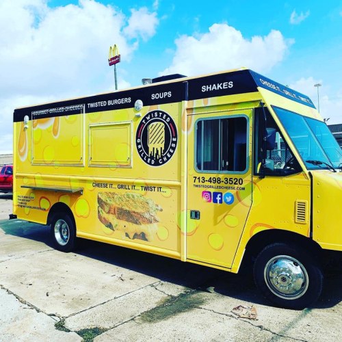 A bright yellow food truck with a cheese theme, offering grilled cheese, burgers, soups, and shakes.