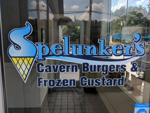 Sign for Spelunker's Cavern Burgers & Frozen Custard, featuring an ice cream cone graphic.