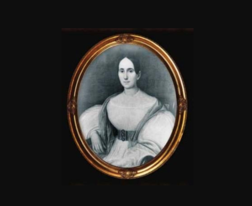 A vintage portrait of a woman in a white dress with puffed sleeves, framed in an ornate gold oval frame.