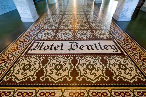 Mosaic floor with intricate patterns featuring the text "Hotel Bentley" in the center.