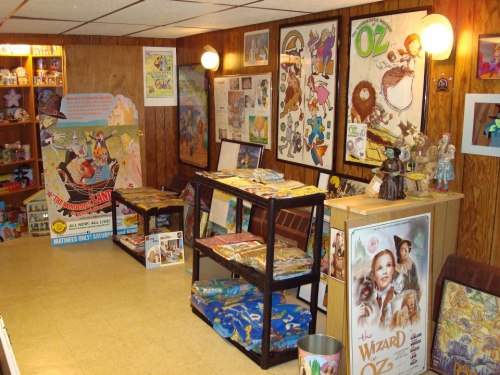 A cozy room filled with "Wizard of Oz" memorabilia, including posters, toys, and colorful displays.