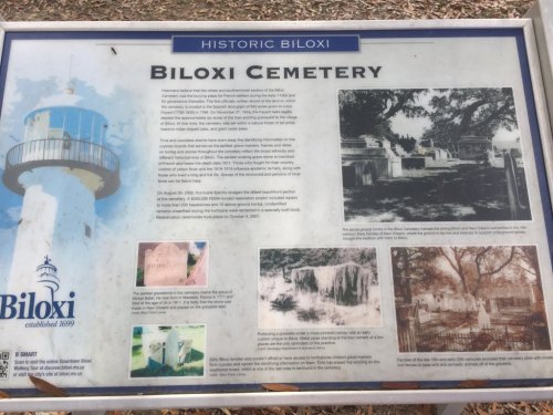 Sign about Biloxi Cemetery, featuring historical photos and information about its significance and notable features.