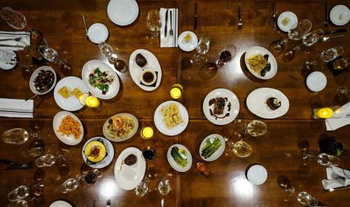 Aerial view of a dining table set with various dishes, glasses, and candles, creating an inviting atmosphere.