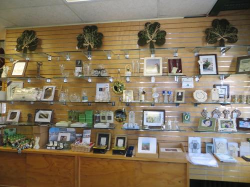 A display wall featuring various decorative items, frames, and gifts arranged on shelves in a shop.
