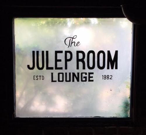 Frosted window featuring the text "The Julep Room Lounge" with "estd 1982" below.