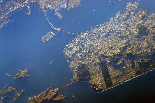 Aerial view of San Francisco, showcasing the Golden Gate Bridge and surrounding water and islands.
